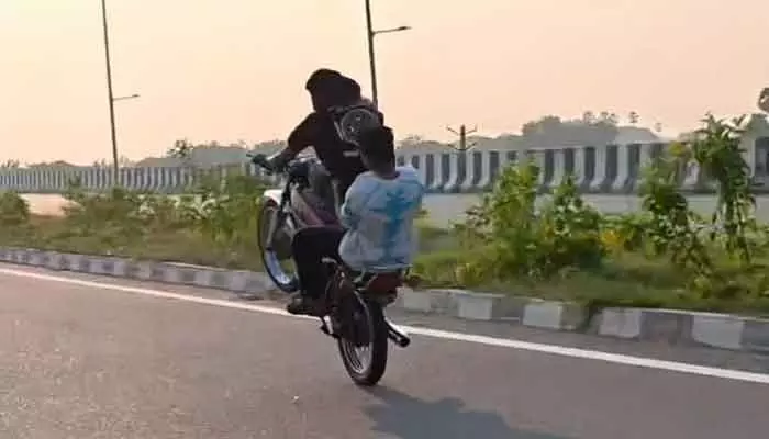 Youths performing risky bike stunts on Khammam–Hyderabad Highway in Maddulapalli are causing fear among locals.